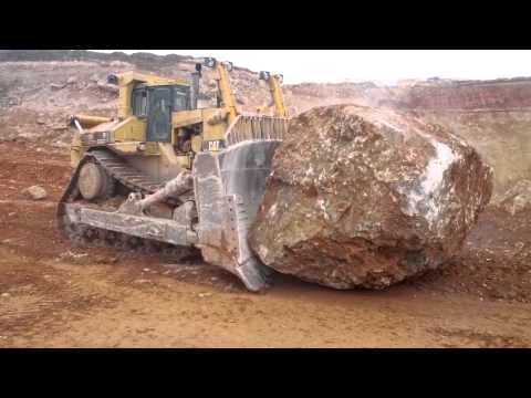 Caterpillar D11R pushing another massive rock