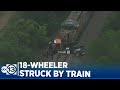 Driver injured after 18-wheeler struck by train near Hockley