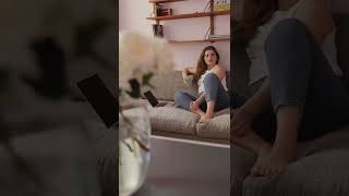Woman Sitting on Couch Next to Laptop Holding a Coffeecup [Short]