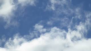White Clouds Moving Across a Deep Blue Sky