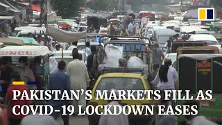 Coronavirus: crowds return to Pakistan’s markets as lockdown eased despite rising case numbers