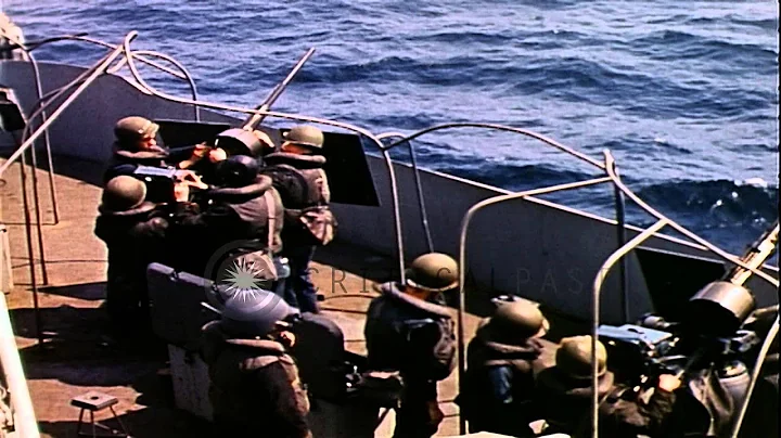 Three 20mm anti aircraft gun crew members fire a g...