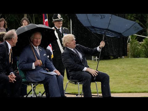 Boris Johnson struggles with umbrella at police memorial unveiling