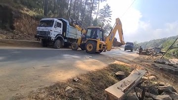 jcb loading boulder in a dump truck