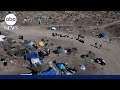 Migrant encampments surge at border as asylum process bottlenecks