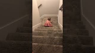 Little girl flips forward down carpeted stairs
