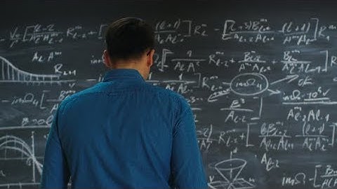 Brilliant Young Academic Approaches Blackboard with Complex Mathematical Formula | Stock Footage -