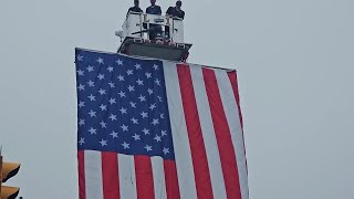 Giant flag unfurled before police officer funeral