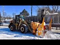 Snow Removal Operation Plowing Snow then Blowing into Trucks