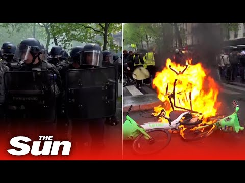 Paris protesters set bikes on fire and police use tear gas as violence erupts during May Day