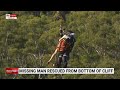 Missing Qld man rescued from cliff fall