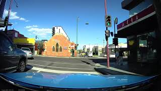 Asian driver driving down the wrong side of the road by turning Right illegally.