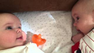 Twins talking and smiling to each other for the first time