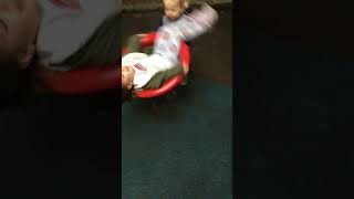 Girl spins on ride at park and accidentally kicks boy on head