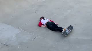 Skateboarder rides bowl and lands awkwardly