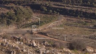 Israeli military vehicles move inside the Golan Heights buffer zone bordering Syria