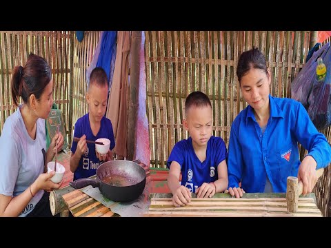 The girl makes a table from bamboo, cooks with her children, the rain is pouring