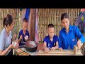 The girl makes a table from bamboo, cooks with her children, the rain is pouring