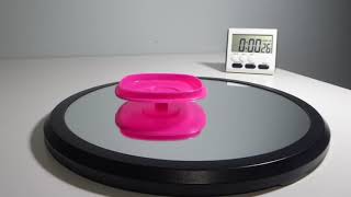 Square Pink Plastic Cap Wobbles When Spun Magically Trying to Raise Heavy Bottom
