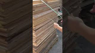 the process of tying a stack of plywood using sturdy plastic rope #automobile
