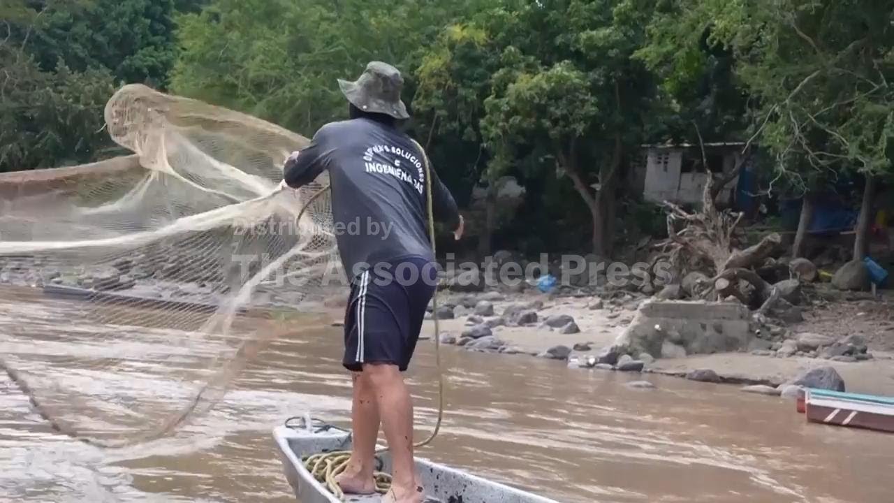 Fishermen crowd banks of Colombia river as annual upstream migration of fish gets under way