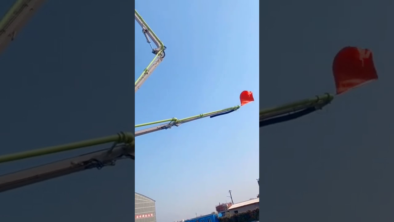 Raising national flag with the mobile tower crane on the construction site