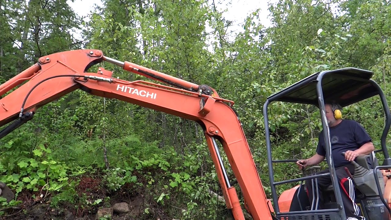 Pulling weeds with a Hitachi mini excavator