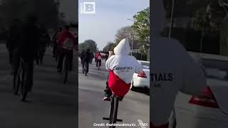 Driver Weaves Dangerously Through Massive Pack of Bicycles on Road