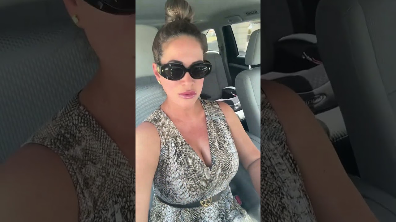 Chic Car Ride: Stylish Woman Poses in Snakeskin Dress