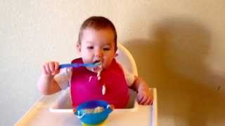 Baby Avy self feeding with spoon and bowl at 11 months (baby led weaning)