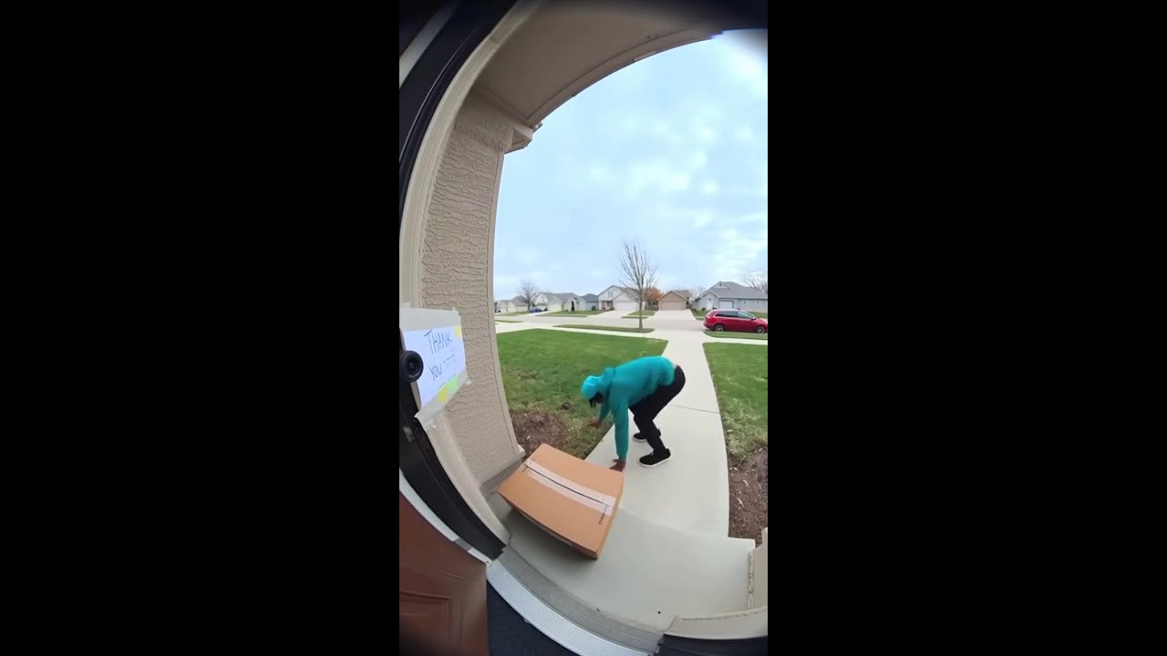 A Ring doorbell view of a delivery driver. 