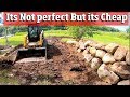 How to Install a CHEAP Boulder Retaining wall with just a skid steer and scrap field stones