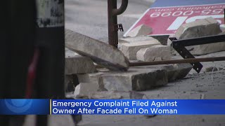 Emergency complaint filed against owner after building façade fell on woman