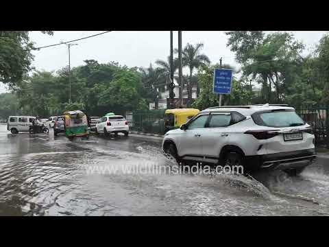 Waterlogged road in Chhatarpur, Delhi: Cars and autos wade through monsoon rain
