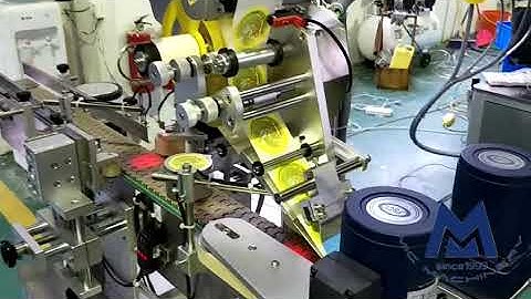MIC fixed position top surface labeling machine