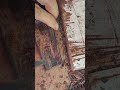 making a neat small circle pattern on a grey concrete wall surface using an industrial iron mold