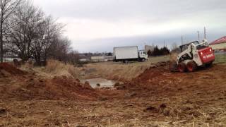 Bobcat s185 digging a retention pond.