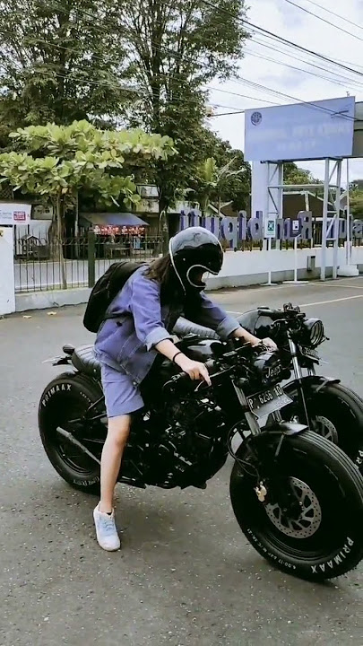 cool girl riding cafe racer