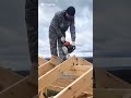 skillfully performing completed wooden roof trusses or rafters.