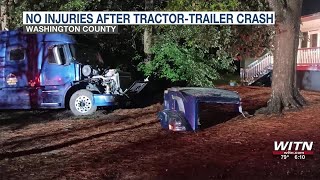 No injuries after tractor-trailer crashes into yard