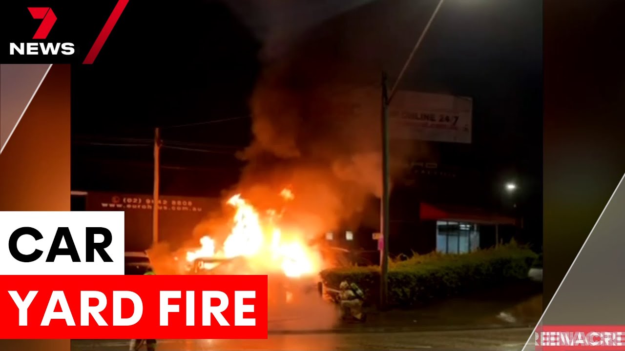 Car yard in flames after suspected arson attack | 7NEWS