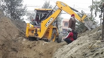 JCB Backhoe Digging Soil For House Foundation