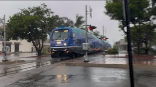 Coaster 672-15 departing from Carlsbad Village Station in the Atmospheric River with the CEM consist