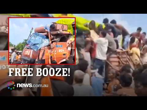 Crowd scrambles for liquor bottles after truck crashes in India's alcohol-free state