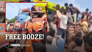 Crowd scrambles for liquor bottles after truck crashes in India's alcohol-free state