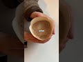 A coffee cup with no lid and no straw.