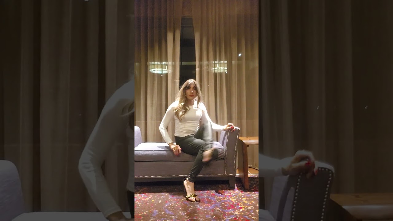 crossdresser posing in lobby of hotel 