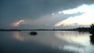 Time lapse over Ocheda Lake of storms with floating weedbergs