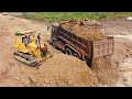 Great machine in Action -DumpTruck Unloading Dirt And Bulldozer Pushing Dirt