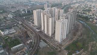 Modern high-rise apartment towers alongside elevated metro rail and river | CHENNAI 4K Drone Footage